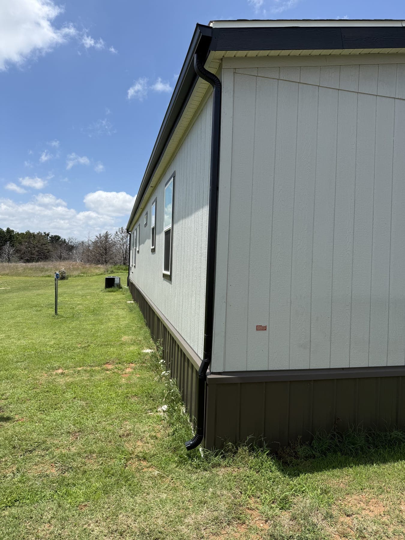 New gutters on a country home surrounded by open acreage near Kingfisher, OK