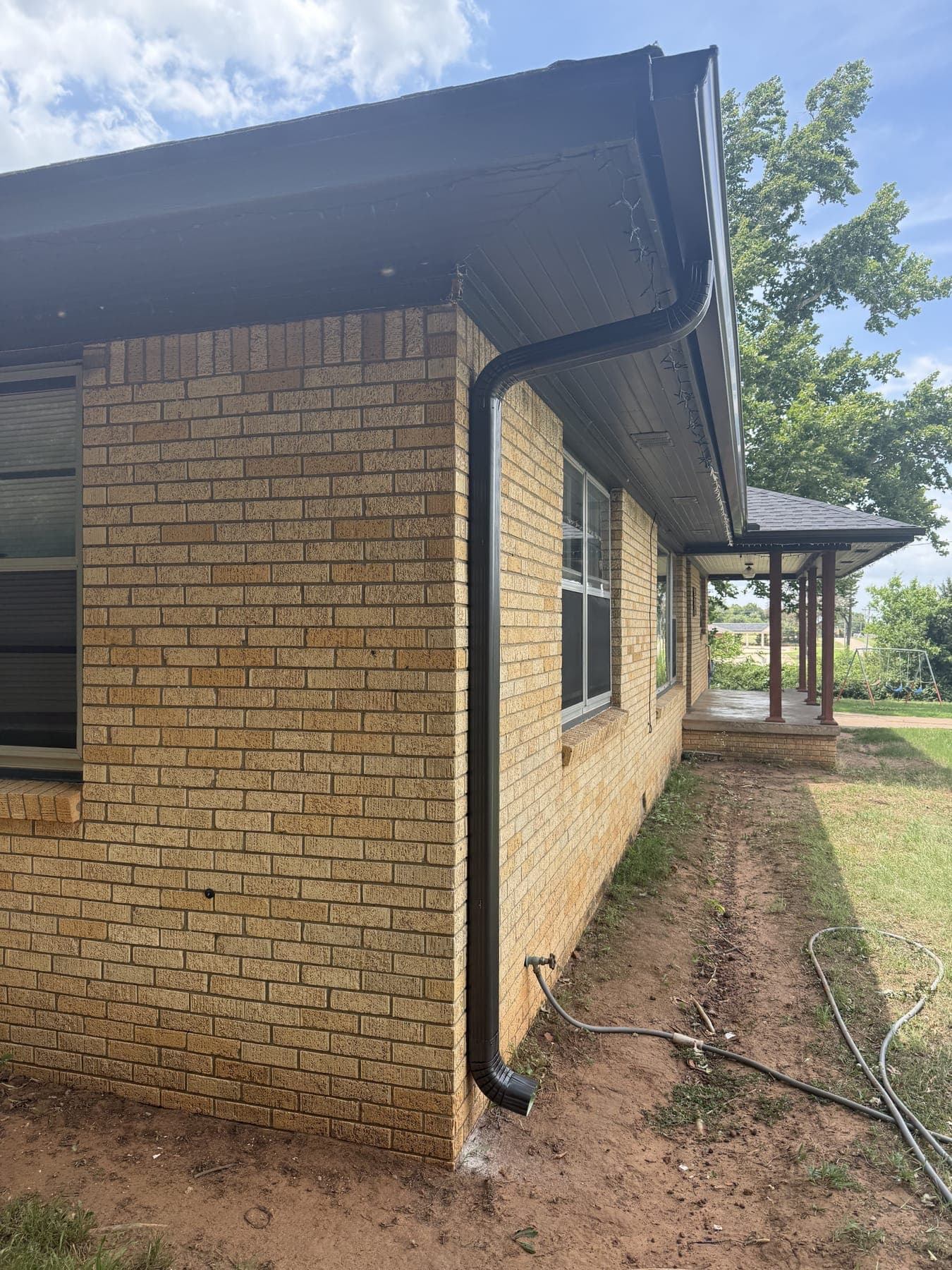 Seamless gutters and downspout on a brick home in Guthrie, OK