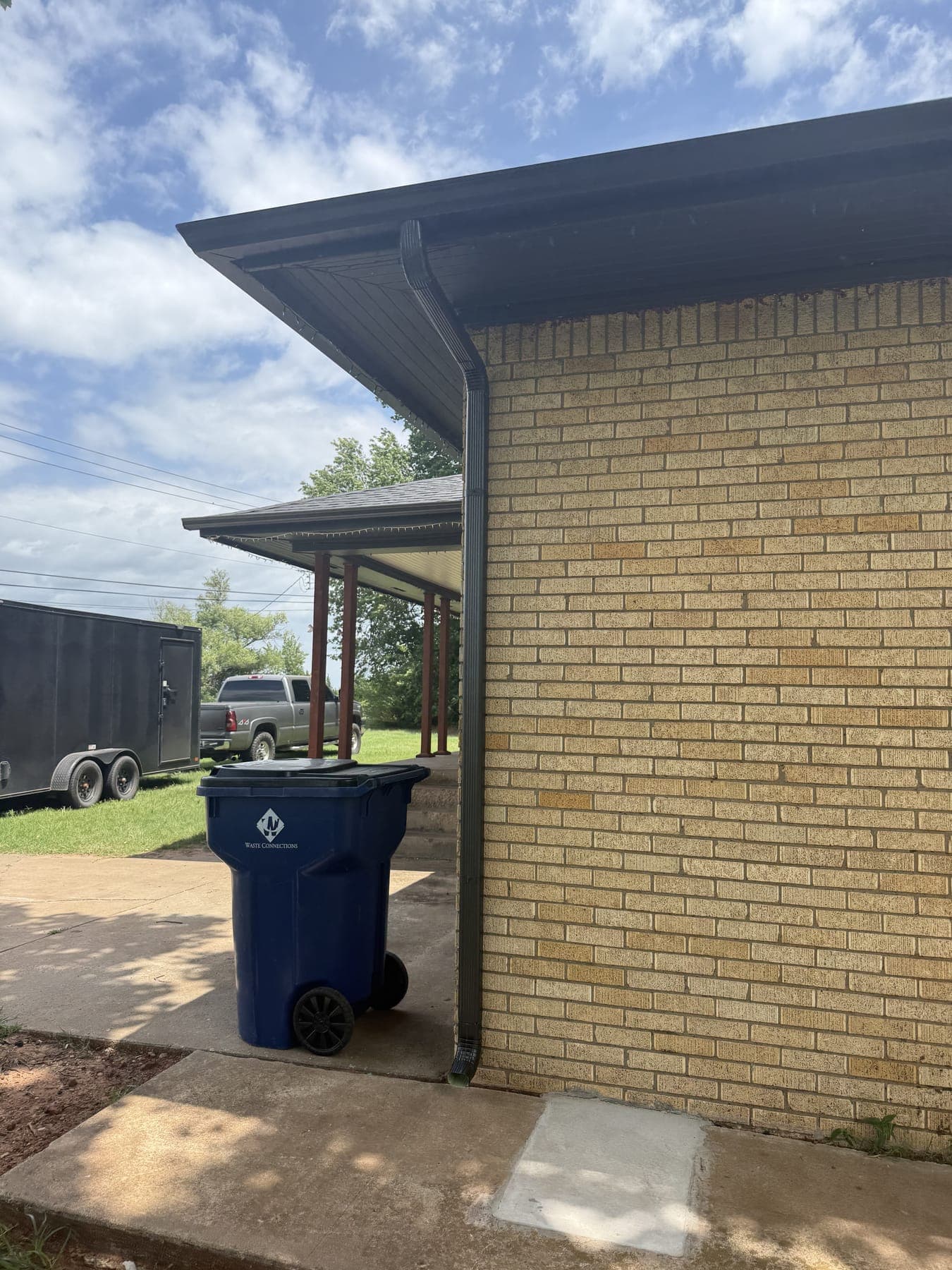 Local Guttering Services work truck and trailer at a gutter installation in central Oklahoma